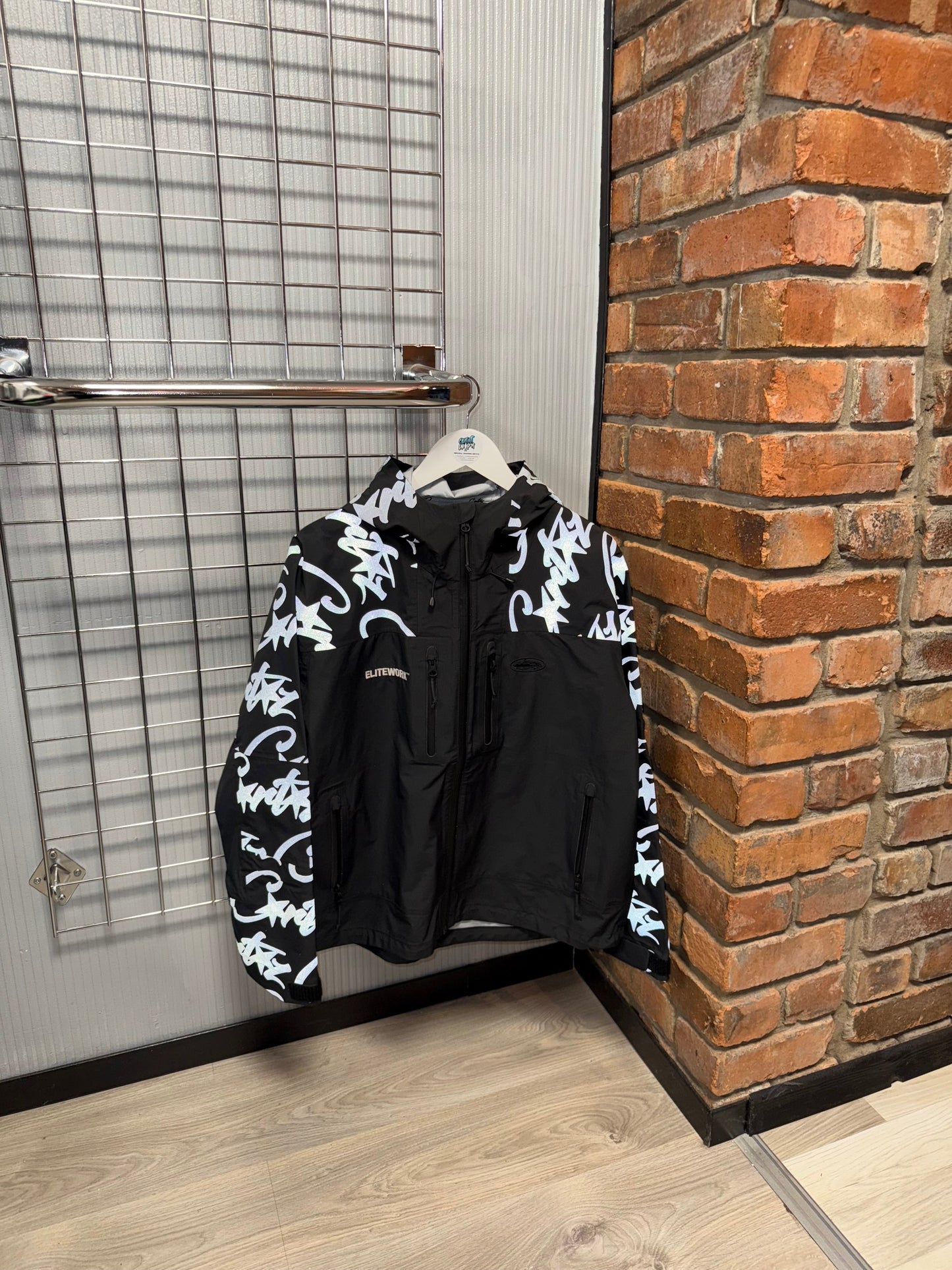 Corteiz Elitework Windrunner Jacket Black | Reflective Silver